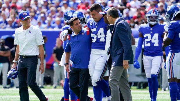 New York Giants inside linebacker Blake Martinez (54) is helped off the field in the first half at MetLife Stadium on Sunday, Sept. 26, 2021, in East Rutherford.